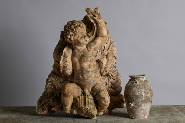 Mid to Late 18th Century Terra Cotta Fountainhead of a Putto Riding a Dolphin