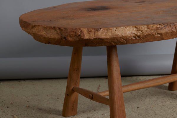 Primitive Oval Top Burled Teak Coffee Table with a Turned Stretcher Base