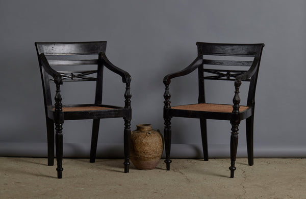 Pair of Ebonized Raffles Chairs with Greeted Arms Gadrooned Legs and Tanned Seats