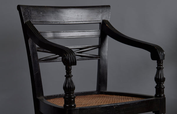 Pair of Ebonized Raffles Chairs with Greeted Arms Gadrooned Legs and Tanned Seats