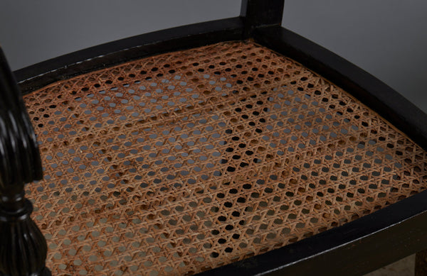 Pair of Ebonized Raffles Chairs with Greeted Arms Gadrooned Legs and Tanned Seats