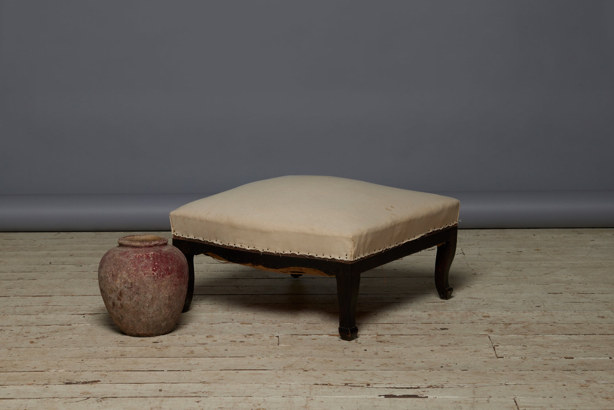 Shaped French Upholstered Ottoman with Cabriolet Legs