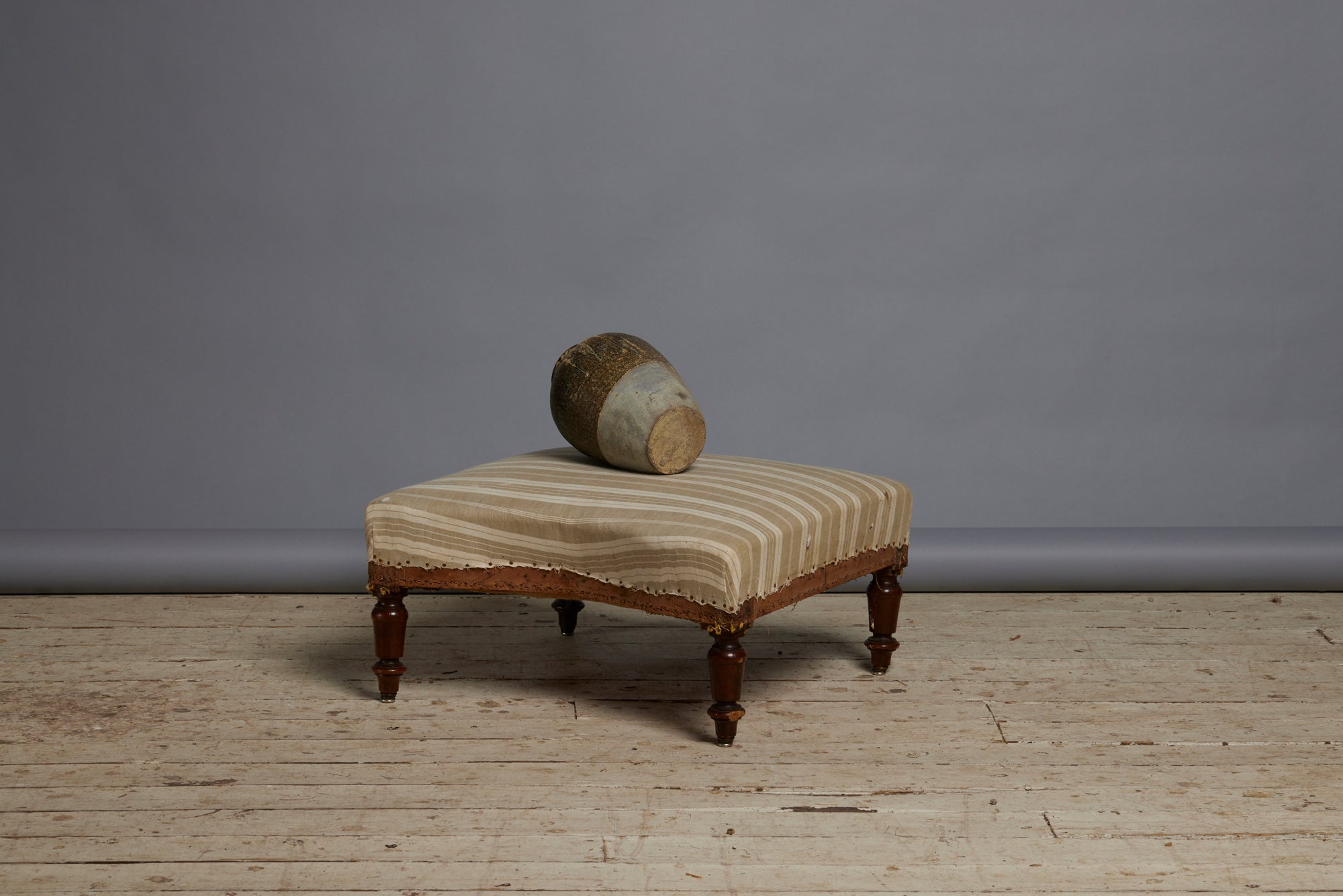 Shaped French Upholstered Ottoman with Simple Turned Legs