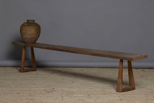 A Wide Top Splayed Leg Early Teak Bench with Beautiful Butterfly Repairs to the Top and a Round Tapered Leg