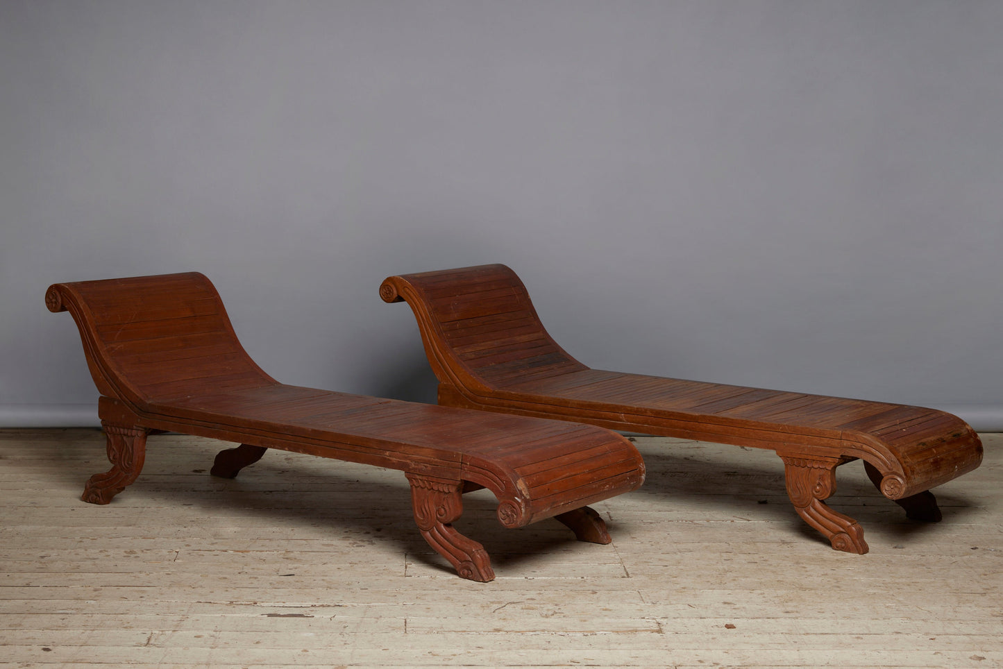 Pair of Slat Seated 19th Century Dutch Colonial Carved Teak Neo Classic Chaises with Stylized Lion Paw Feet and Rosettes