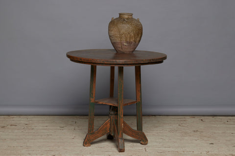 Late 19th Century Arts and Crafts Style Round Top Primitive Teak End Table with a Small Display Shelve Underneath with Traces of Old Green Paint