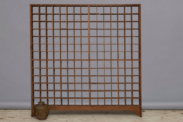 Late 19th Early 20th Century Teak Shallow Gridded Room Divider with a Delicate Skeletal Base from Jakarta