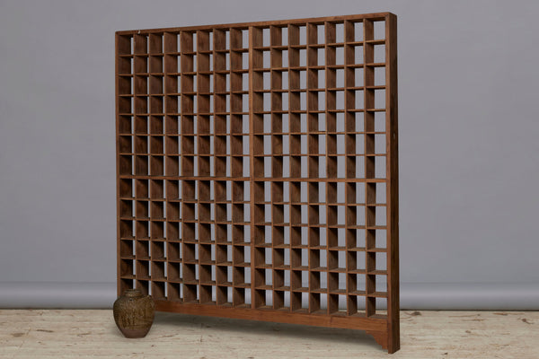 Late 19th Early 20th Century Teak Shallow Gridded Room Divider with a Delicate Skeletal Base from Jakarta