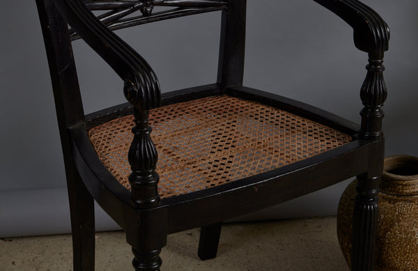Pair of Ebonized Raffles Chairs with Greeted Arms Gadrooned Legs and Tanned Seats