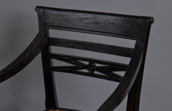 Pair of Ebonized Raffles Chairs with Greeted Arms Gadrooned Legs and Tanned Seats