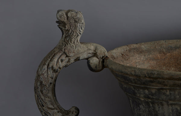 Set of Four English Late 19th Century Cast Lead Urns with Griffin Handles and Cast Applied Puttis in a Challased Form