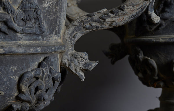 Set of Four English Late 19th Century Cast Lead Urns with Griffin Handles and Cast Applied Puttis in a Challased Form