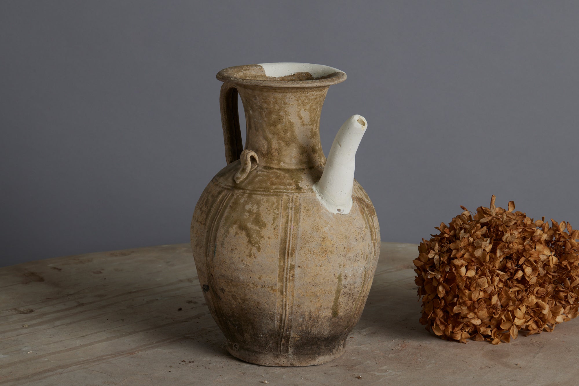 A Yue Wei Dynasty Teapot with Spatterware Decoration and Repairs to the Spout and Upper Lip