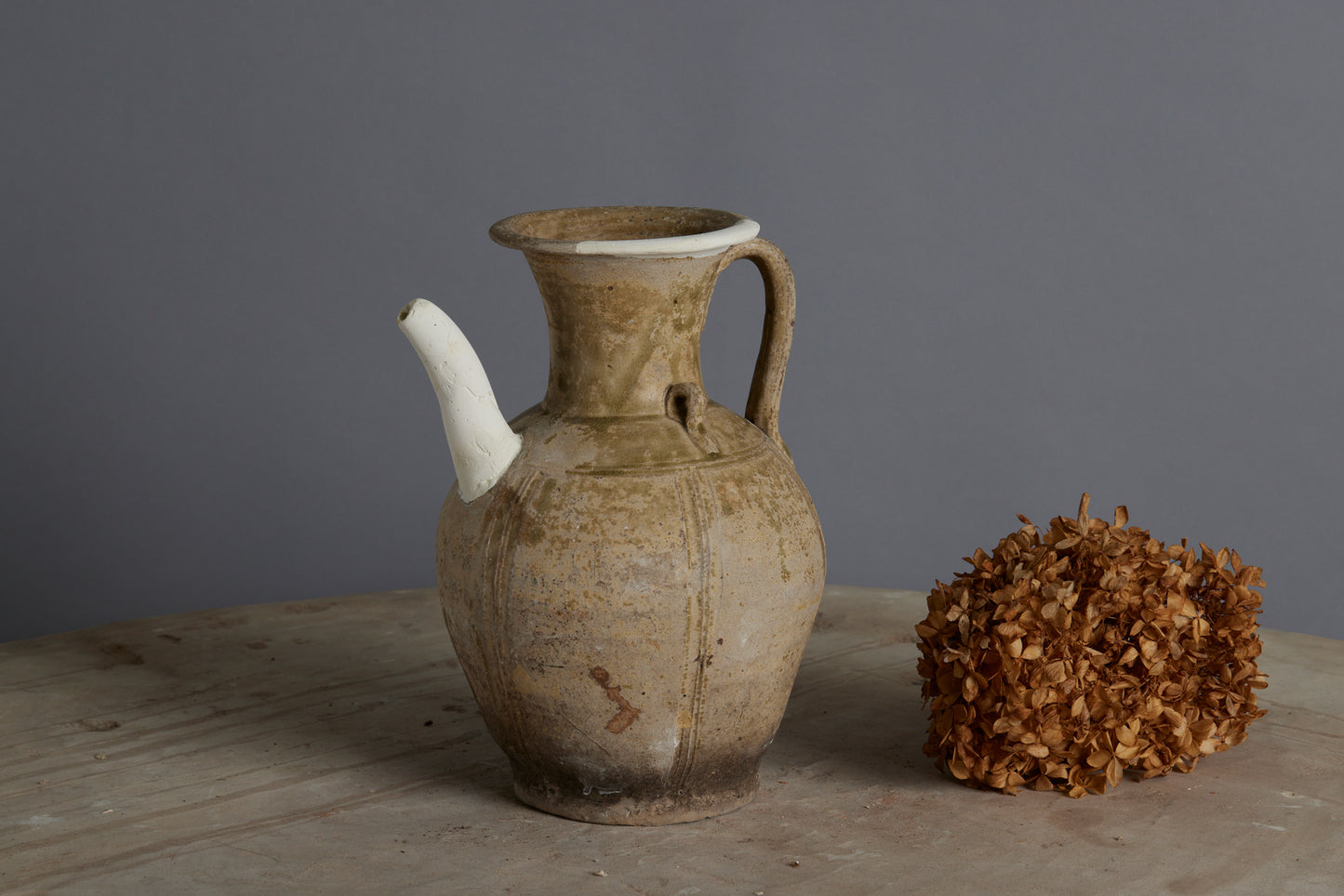 A Yue Wei Dynasty Teapot with Spatterware Decoration and Repairs to the Spout and Upper Lip