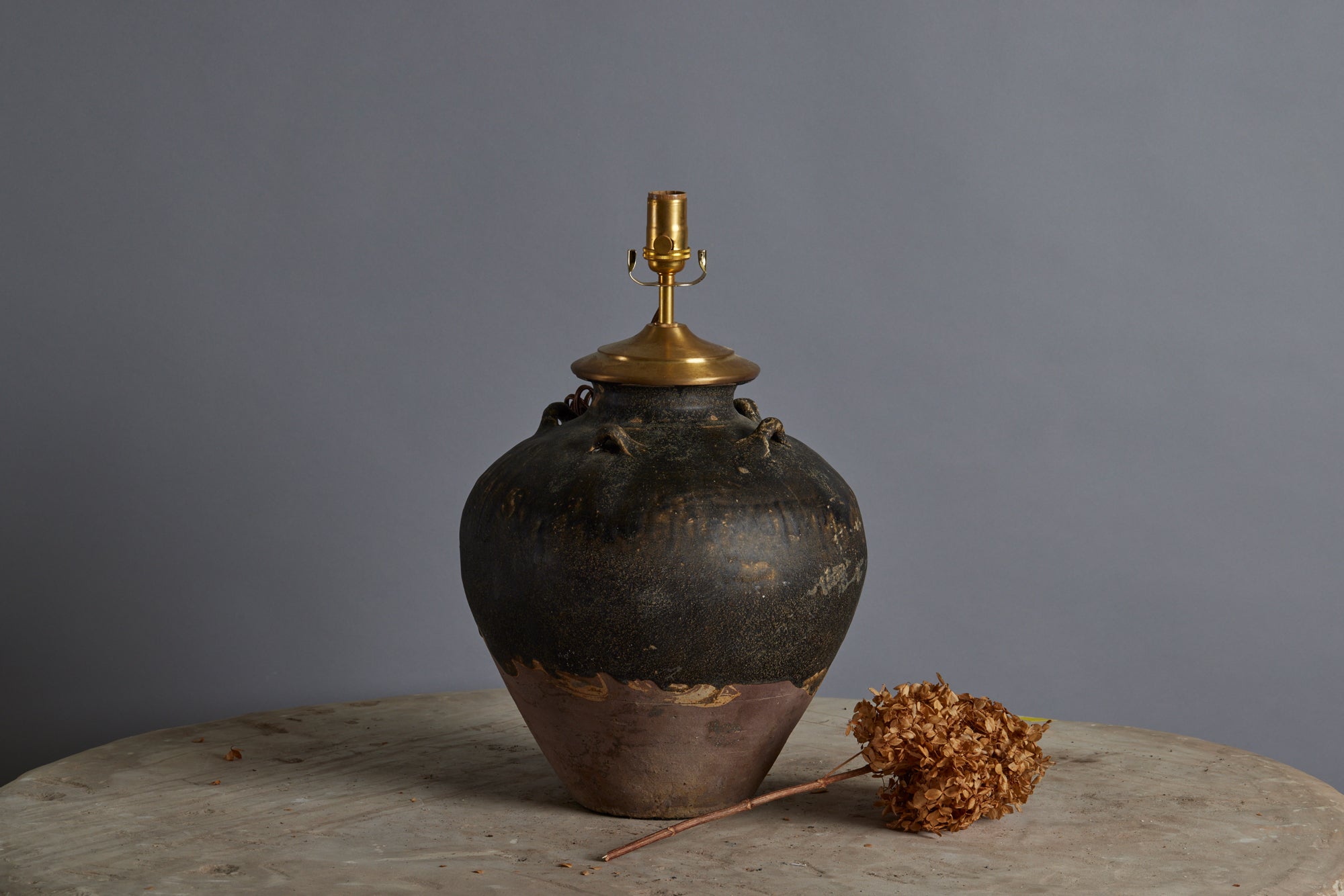 A Two Tone Chocolate Covered Sung Dynasty Storage Jar from the Musi River Basin in Sumatra as a Lamp